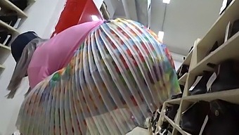 A Sneaky Observer Captures A Tantalizing Display Of A Woman'S Derriere In A Shoe Store